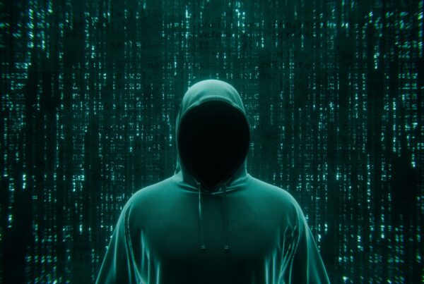 Figura encapuchada sin rostro sobre un fondo de código verde, que ilustra el ataque a una tienda PrestaShop